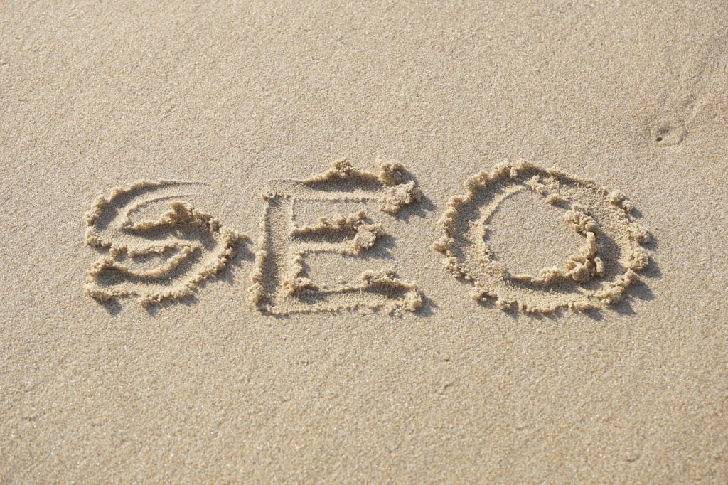 The letters SEO written in sand on a beach representing creating a simple and straightforward SEO strategy 