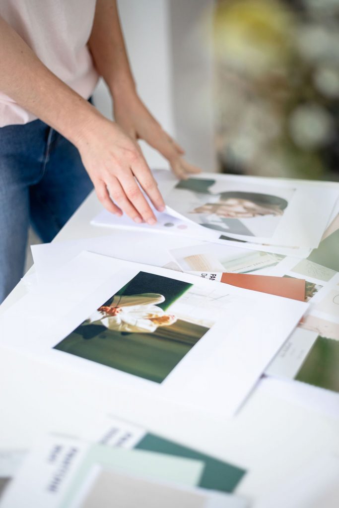 Jane's hands turning the pages of a book with images on the pages